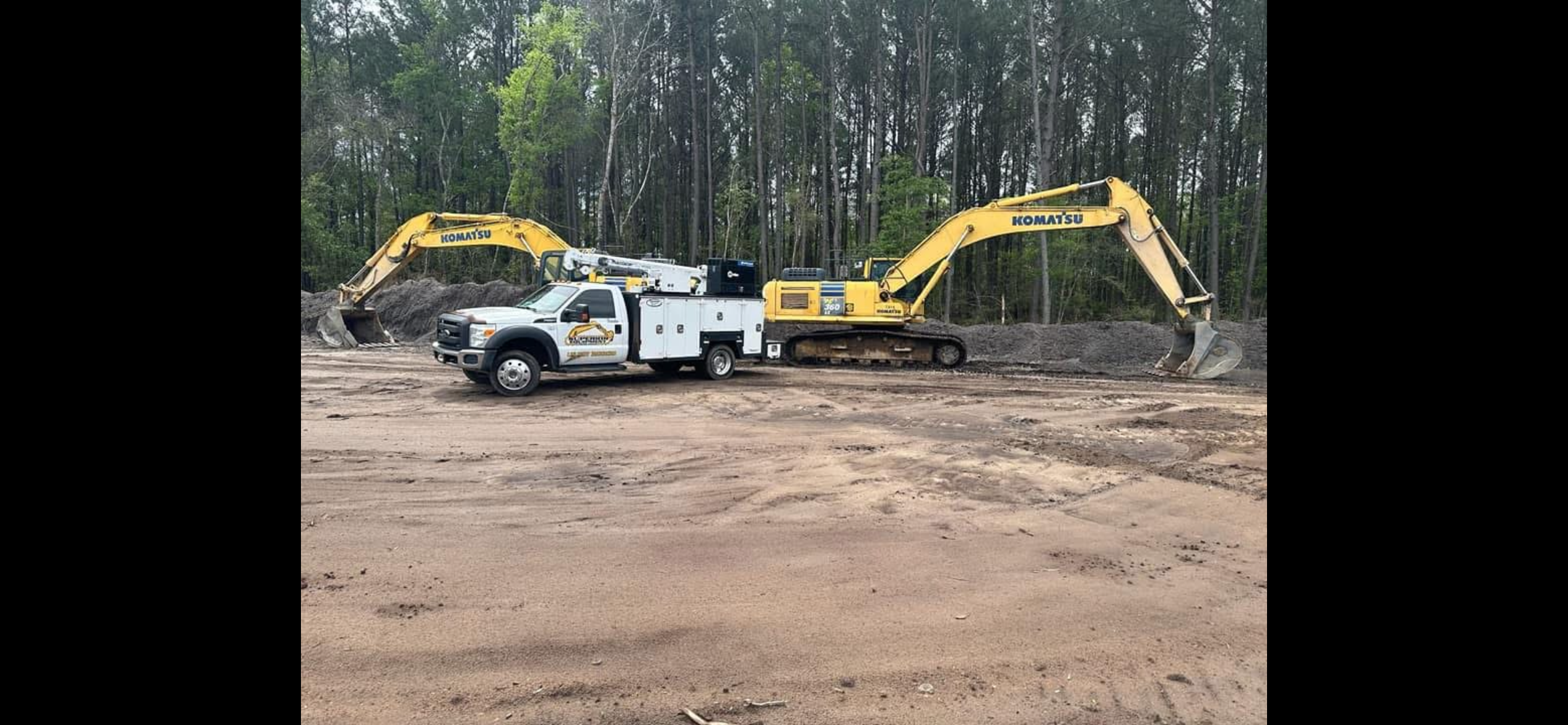 Superior Equipment service truck repairing a Komatsu excavator on-site